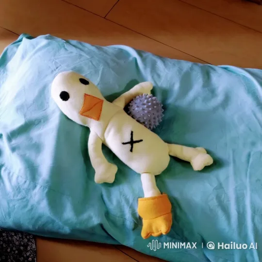 Stuffed Duck Scratches Belly on Blanket – AI Generated Video | Hailuo AI