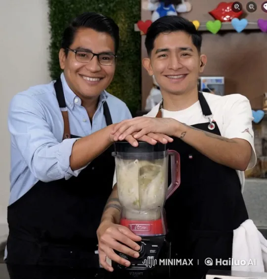 Two Smiling Individuals Share a Kiss Over a Blender in a Joyful Kitchen Scene – AI Generated Video | Hailuo AI