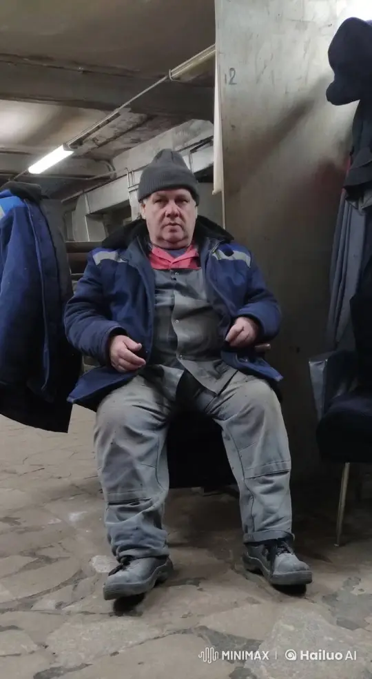 Worker Resting in Dimly Lit Industrial Break Area – AI Generated Video | Hailuo AI