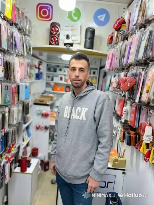 Customer Examines Phone Cases in Modern Shop – AI Generated Video | Hailuo AI