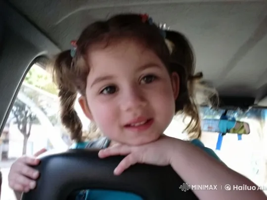 Innocent Curiosity: Young Girl in Car with Playful Gaze – AI Generated Video | Hailuo AI