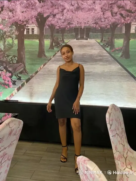 Graceful Woman in Black Amidst Swaying Cherry Blossoms – AI Generated Video | Hailuo AI