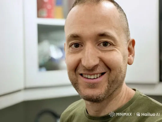 Smiling Man Engages Viewers in Static Room Setting – AI Generated Video | Hailuo AI
