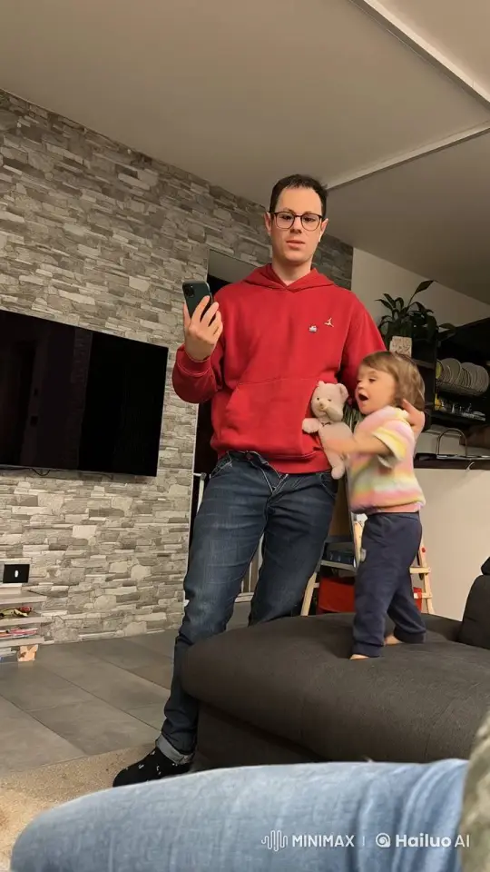 Man with Smartphone Interacts with Excited Child in Living Room – AI Generated Video | Hailuo AI