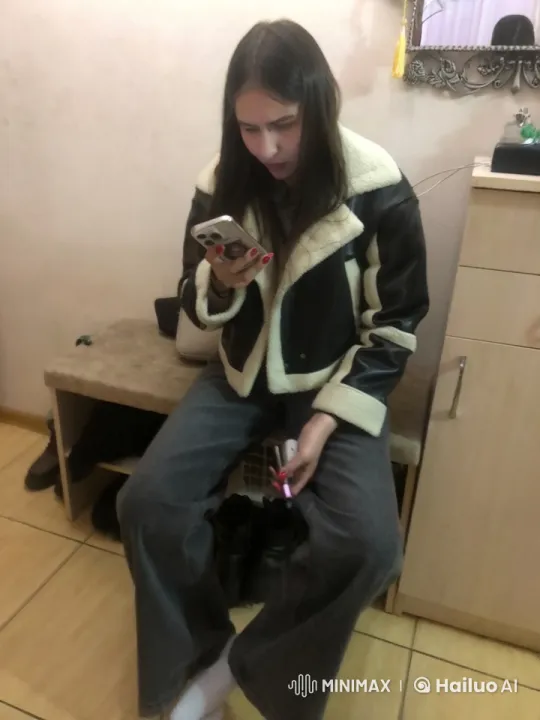 Young Woman Focused on Phone in Homey Setting – AI Generated Video | Hailuo AI