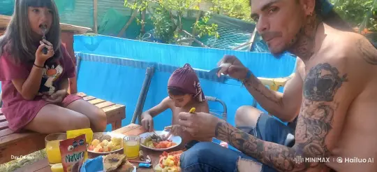 Outdoor Family Meal with Tattoos, Scarf, and Cartoon Shirt – AI Generated Video | Hailuo AI