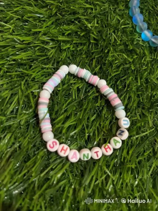 Colorful Beaded Bracelet Sways on Artificial Grass – AI Generated Video | Hailuo AI