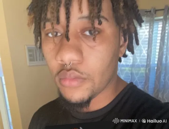 Man in Black Shirt with Septum Piercing in Thoughtful Pose – AI Generated Video | Hailuo AI
