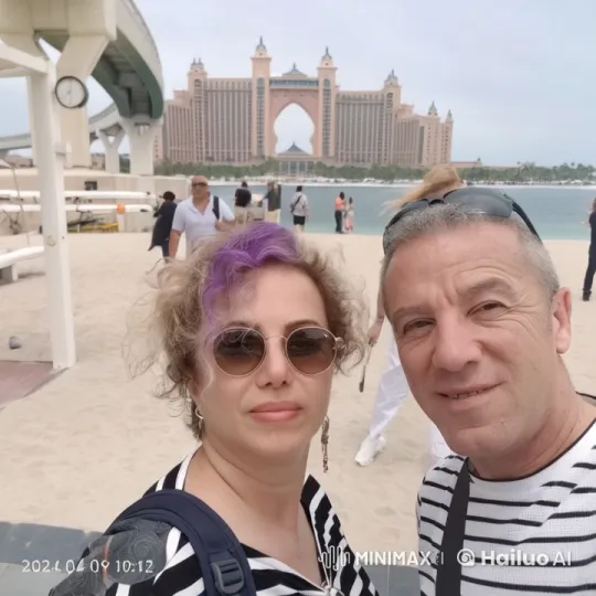 Couple on Beach with Atlantis Hotel in Background – AI Generated Video | Hailuo AI