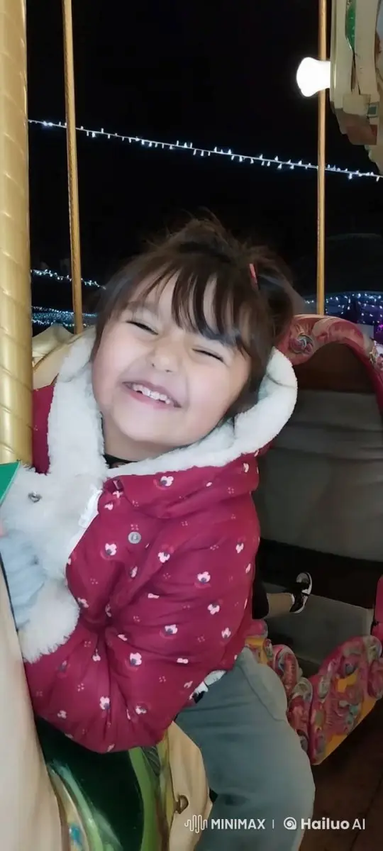 Joyful Child on Carousel Ride Captured in Festive Night – AI Generated Video | Hailuo AI