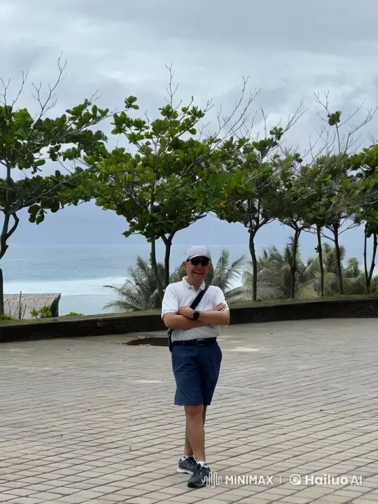 Man Enjoying Coastal View with Gentle Waves – AI Generated Video | Hailuo AI