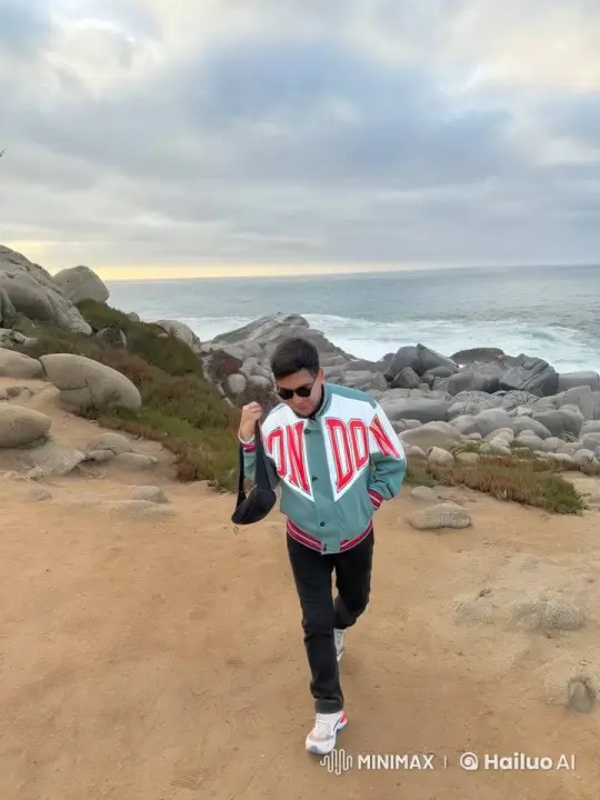 Coastal Stroll with 'LONDON' Jacket Under Setting Sun – AI Generated Video | Hailuo AI