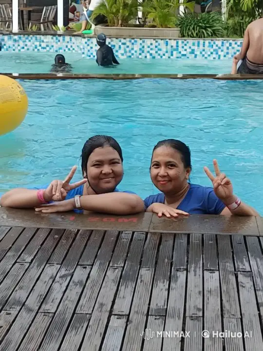 Joyful Poolside Atmosphere with Swimmers and Tropical Setting – AI Generated Video | Hailuo AI