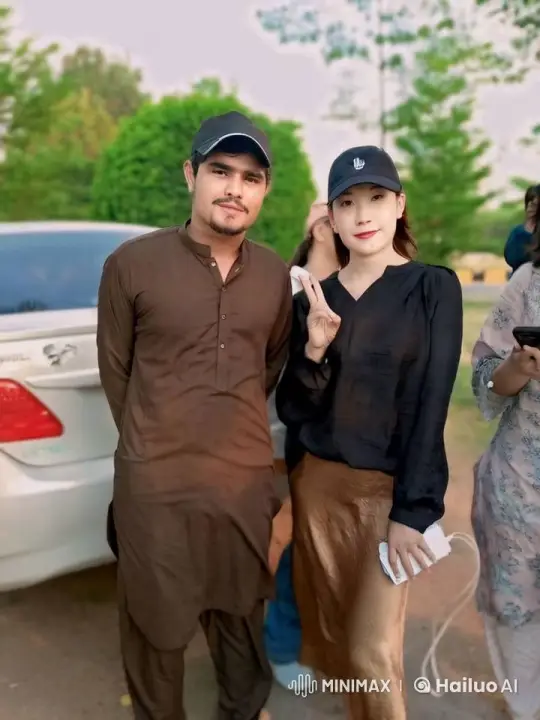 Couple Smiling and Making Peace Sign Outdoors – AI Generated Video | Hailuo AI