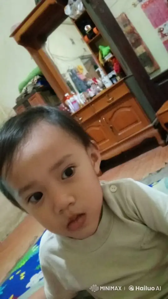 Child in Cozy Room with Gentle Smile – AI Generated Video | Hailuo AI