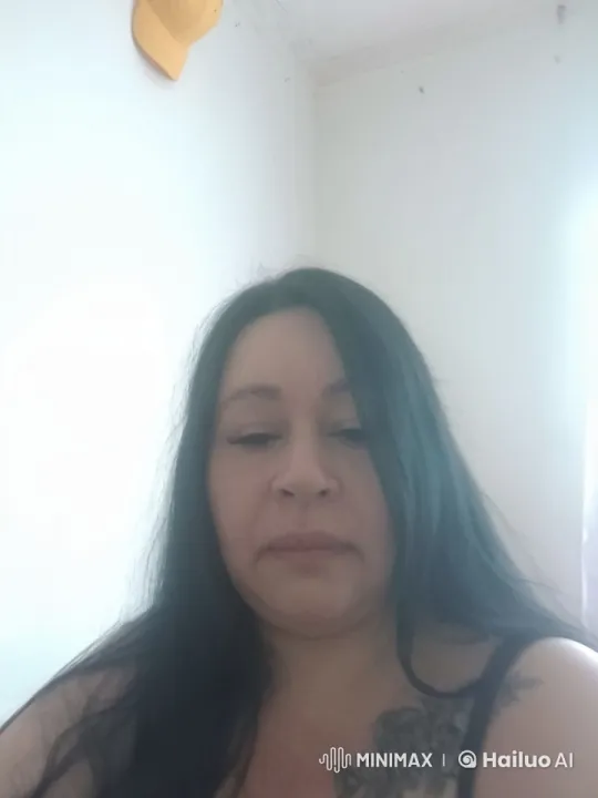 Woman Gently Arranging Her Hair in a Calm Setting – AI Generated Video | Hailuo AI