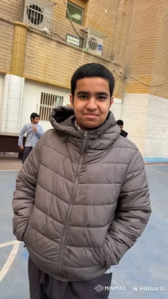 Young Man in Gray Puffer Jacket at Schoolyard – AI Generated Video | Hailuo AI