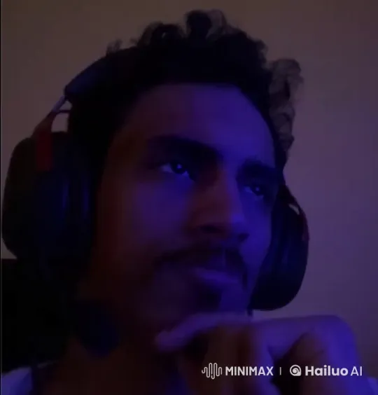 Contemplative Man in Blue Light with Simulated Smoking – AI Generated Video | Hailuo AI