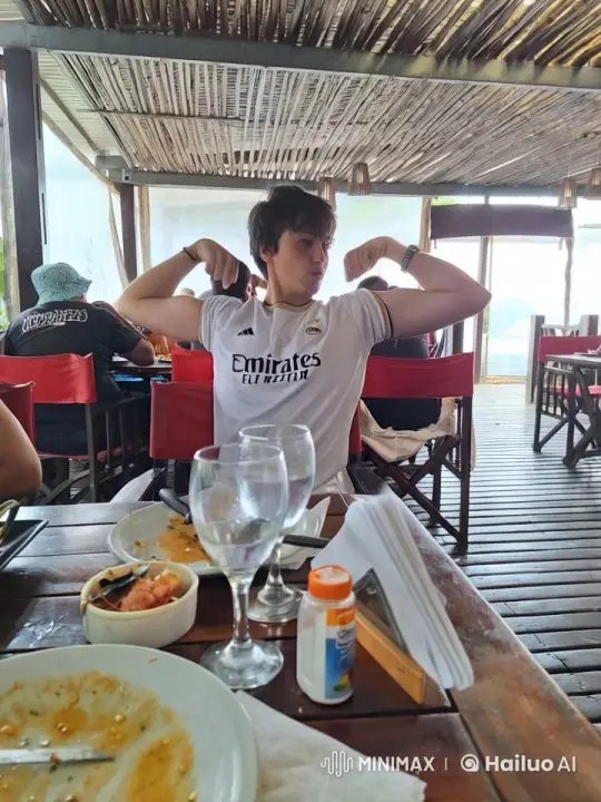 Young Man Dances Ballet with Pink Dolphins at Beachside Restaurant – AI Generated Video | Hailuo AI