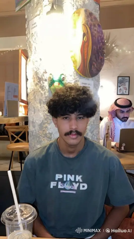 Young Man Smokes Calmly in Cozy Cafe – AI Generated Video | Hailuo AI