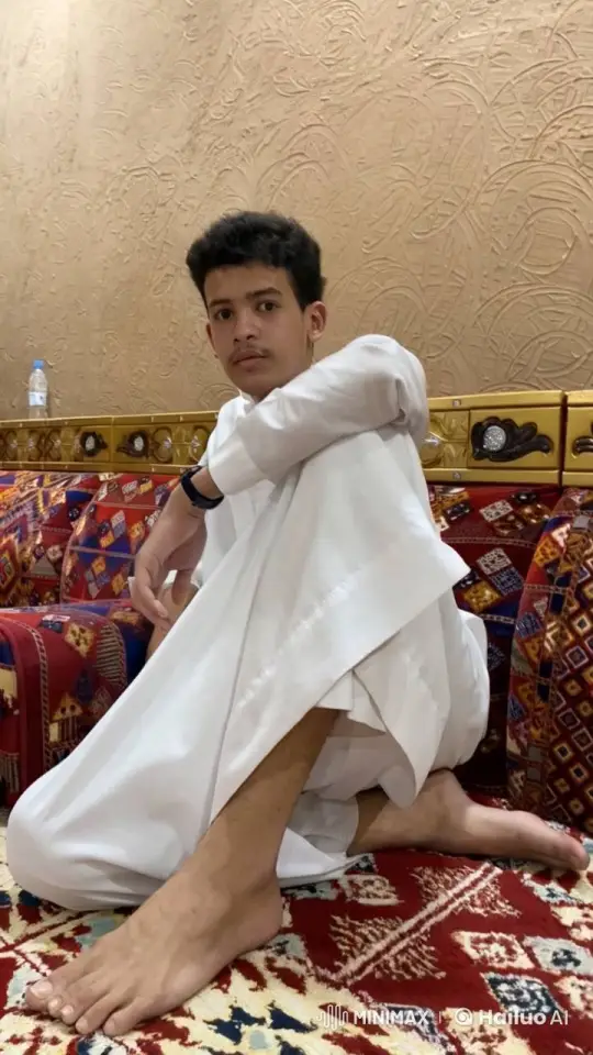 Young Man Relaxing on Patterned Couch Smoking – AI Generated Video | Hailuo AI