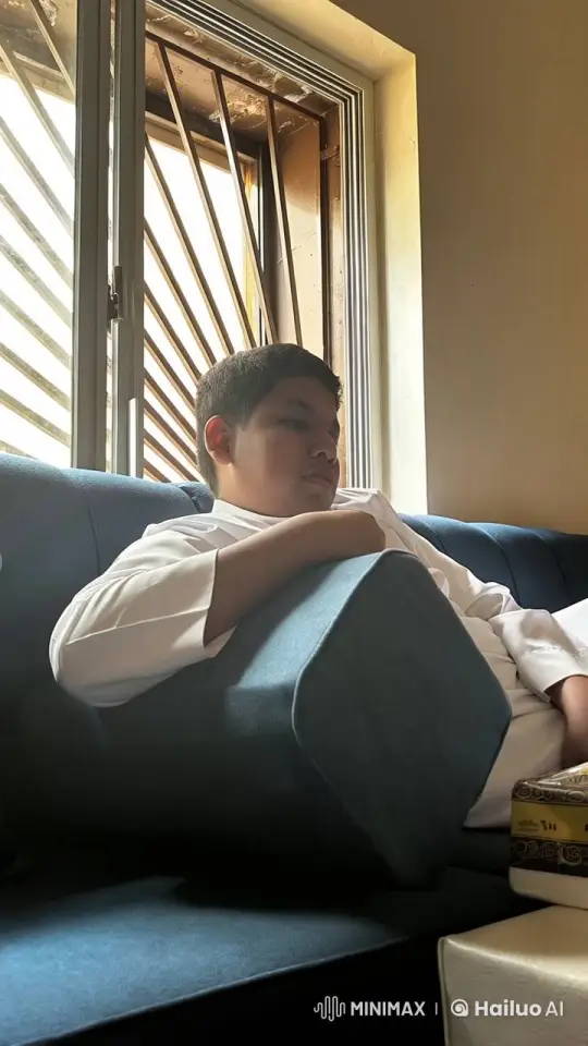 Young Man Reflects with a Cigarette on a Sunny Couch – AI Generated Video | Hailuo AI