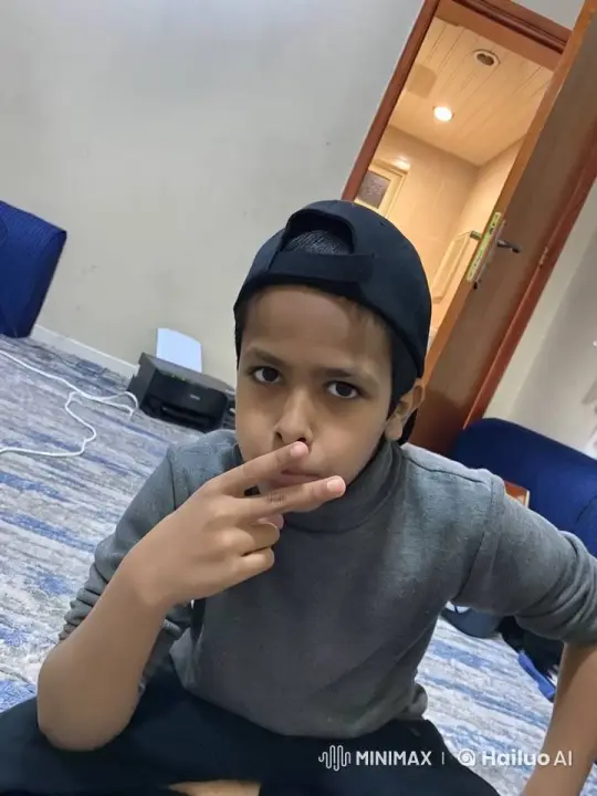 Young Boy Mimics Smoking on Carpeted Floor – AI Generated Video | Hailuo AI