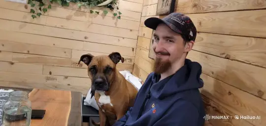 Affectionate Bond Between Person and Dog in Cozy Room – AI Generated Video | Hailuo AI