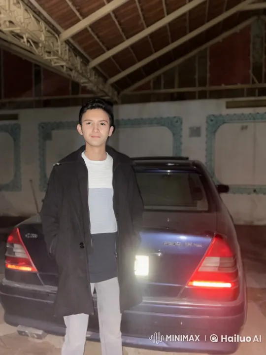 Young Man Smokes Calmly in Moody Garage Setting – AI Generated Video | Hailuo AI