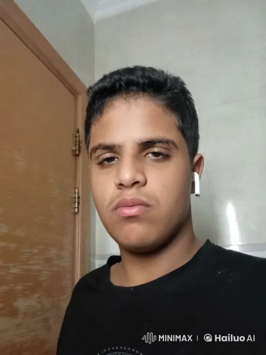 Young Man Smoking in Static Room with Neutral Expression – AI Generated Video | Hailuo AI