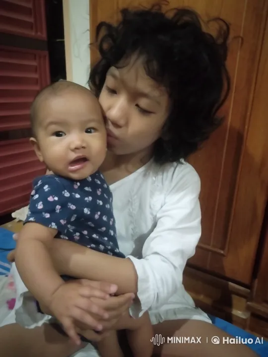 Young Girl Playfully Struggles with Baby Sibling – AI Generated Video | Hailuo AI