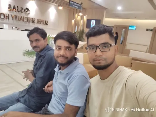 Three Men Lean Closer on Sofa in Waiting Area – AI Generated Video | Hailuo AI