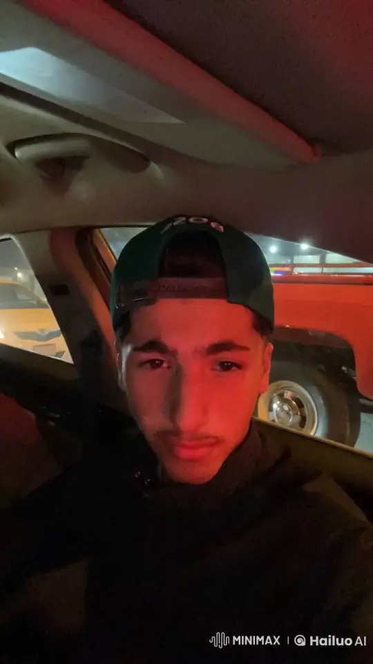 Young Man Smokes in Red-Lit Car at Night – AI Generated Video | Hailuo AI