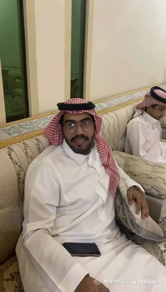 Traditional Attired Man Smokes on Couch with Calm Atmosphere – AI Generated Video | Hailuo AI