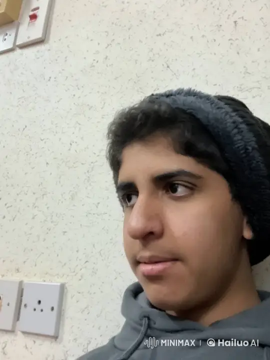 Person in Gray Hoodie Smokes Calmly Against Beige Wall – AI Generated Video | Hailuo AI