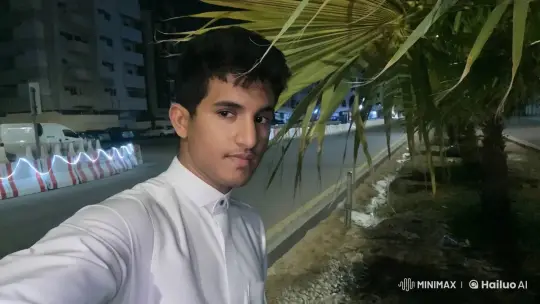Young Man Smoking Under Palm Tree at Night – AI Generated Video | Hailuo AI