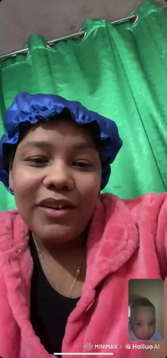 Woman in Pink Robe and Blue Headscarf on Video Call – AI Generated Video | Hailuo AI