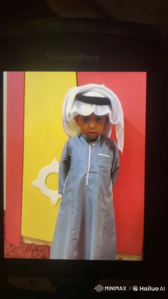 Young Boy Mimics Smoking in Traditional Attire Against Vibrant Background – AI Generated Video | Hailuo AI
