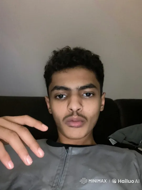 Young Man Reflects with a Cigarette in Dim Light – AI Generated Video | Hailuo AI