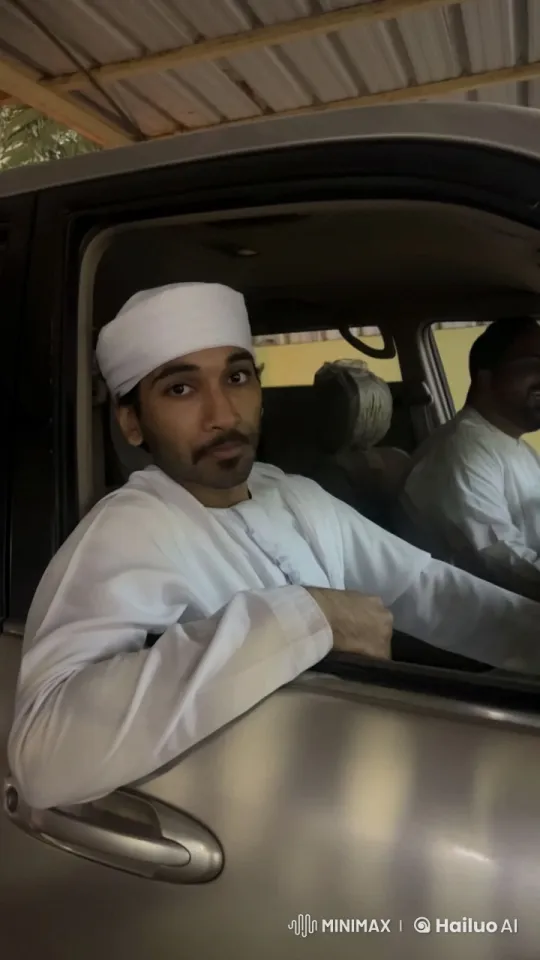 Person in Traditional Attire Smoking in Car with Companion – AI Generated Video | Hailuo AI