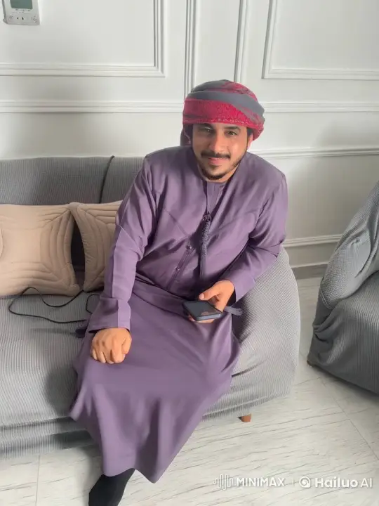 Man Relaxing on Couch, Smoking, Engaged with Smartphone – AI Generated Video | Hailuo AI