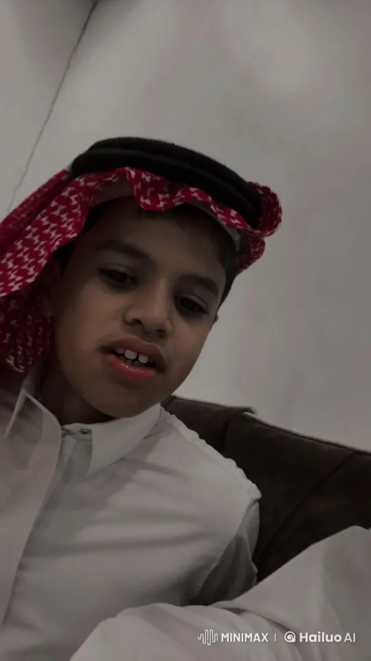 Young Boy in Traditional Attire Contemplates on Couch – AI Generated Video | Hailuo AI