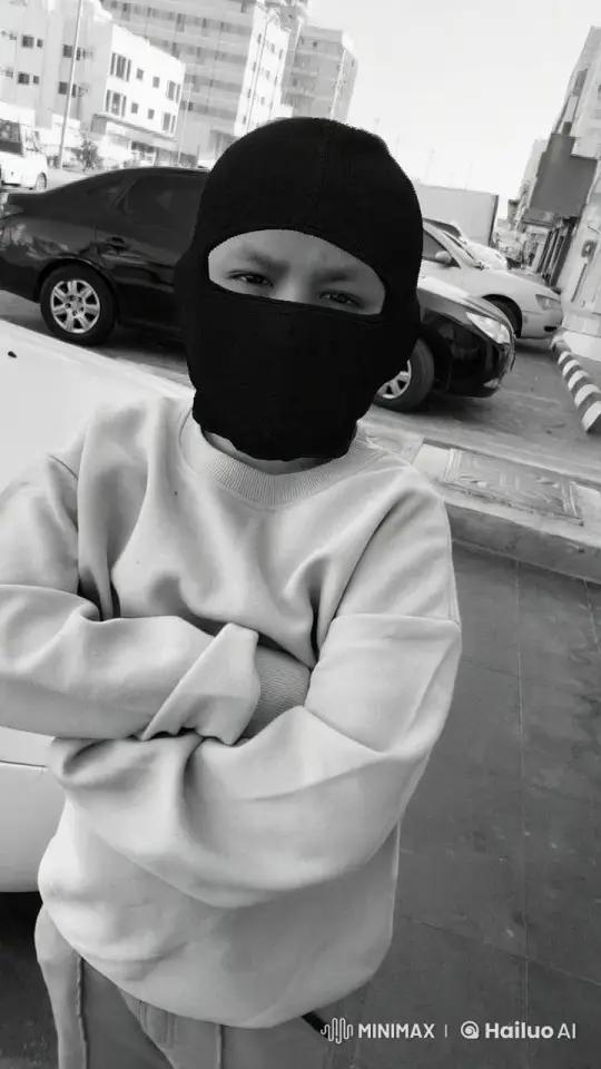 Person in Balaclava Stands Still Amidst Urban Street – AI Generated Video | Hailuo AI