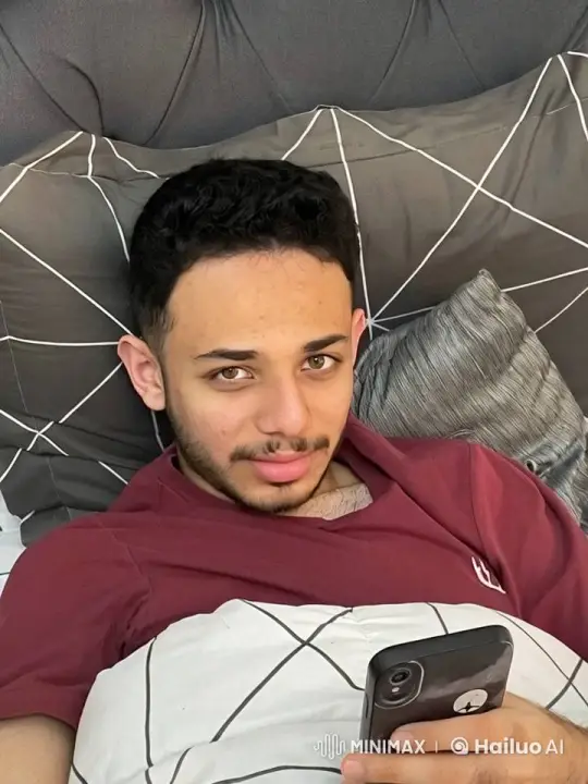 Young Man Relaxing in Bed, Smoking and Using Phone – AI Generated Video | Hailuo AI