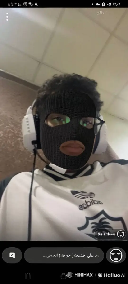 Young Person Exhales Smoke with Balaclava in Lit Room – AI Generated Video | Hailuo AI