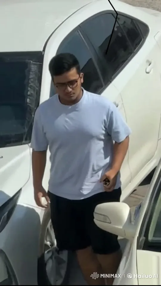 Person Smoking Between Cars in Sunny Parking Lot – AI Generated Video | Hailuo AI