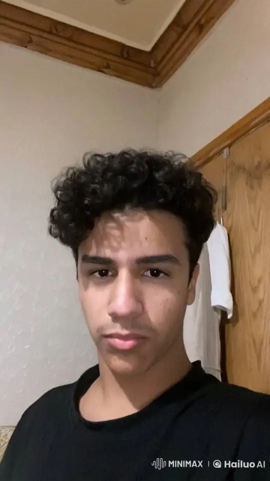 Young Man Contemplatively Smokes in Neutral Room – AI Generated Video | Hailuo AI