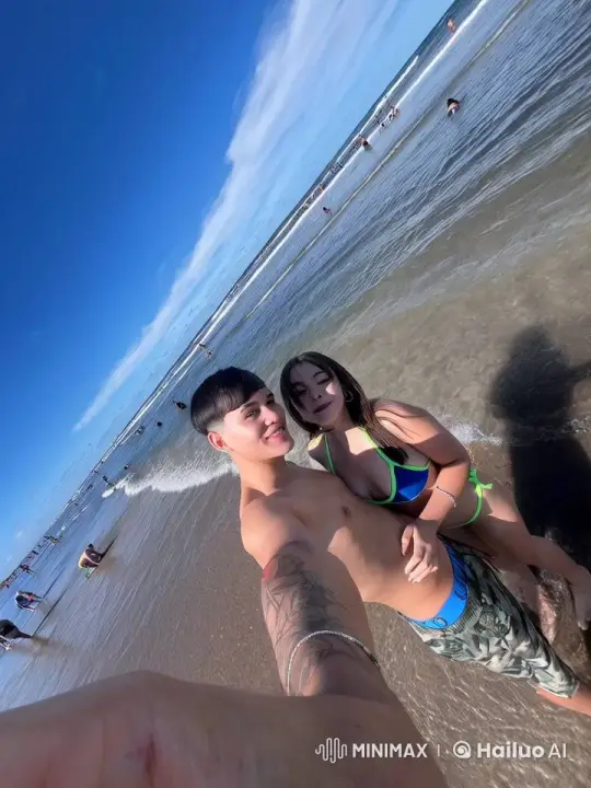 Joyful Couple Takes Selfie at Lively Beach – AI Generated Video | Hailuo AI