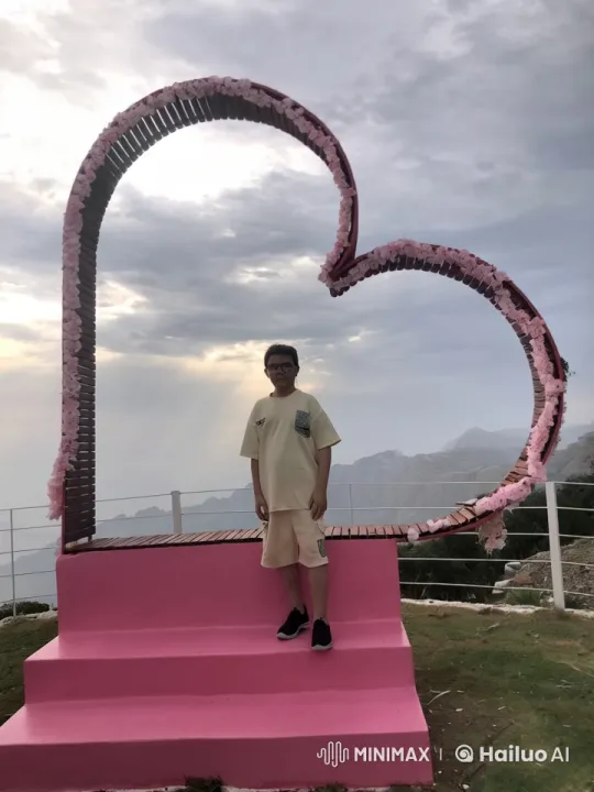 Person Smokes on Pink Platform with Heart Structure – AI Generated Video | Hailuo AI