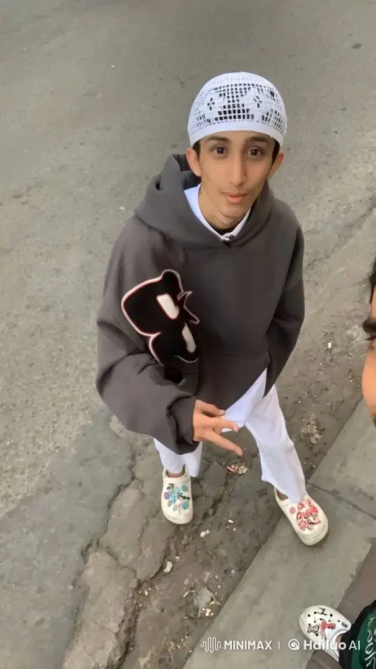 Young Individual Smoking on Urban Sidewalk – AI Generated Video | Hailuo AI